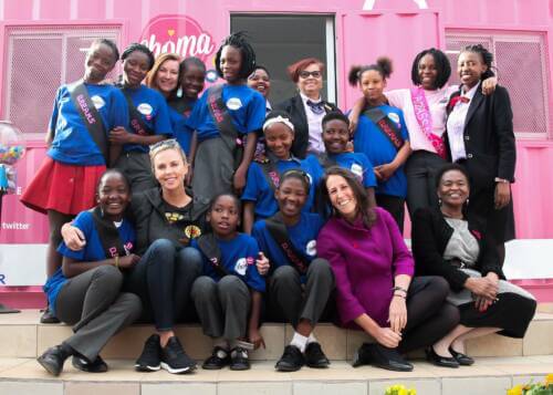 Actor Charlize Theron with a group of young people at the Choma Café