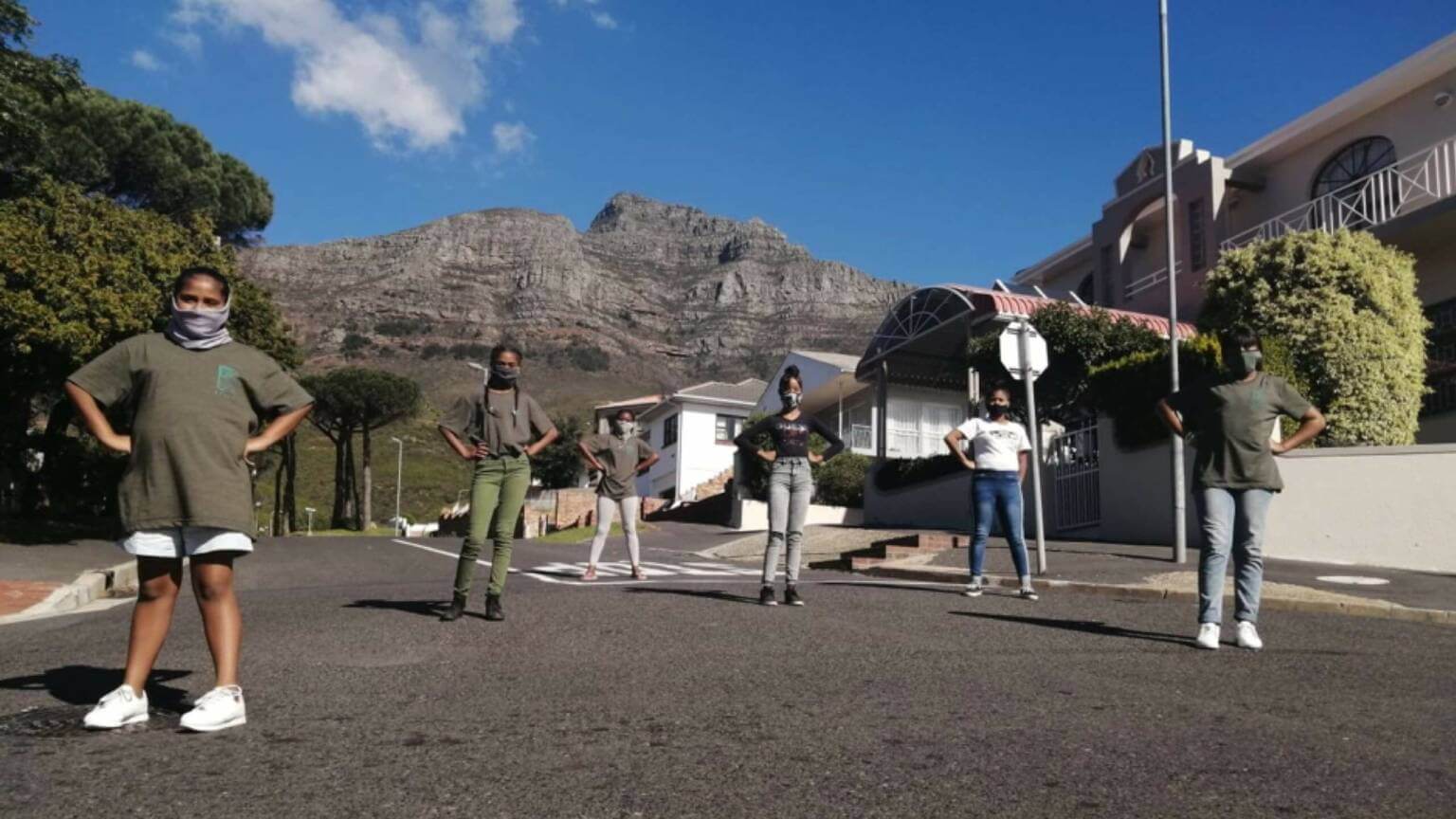 Assertive young people standing in a street under a blue sky