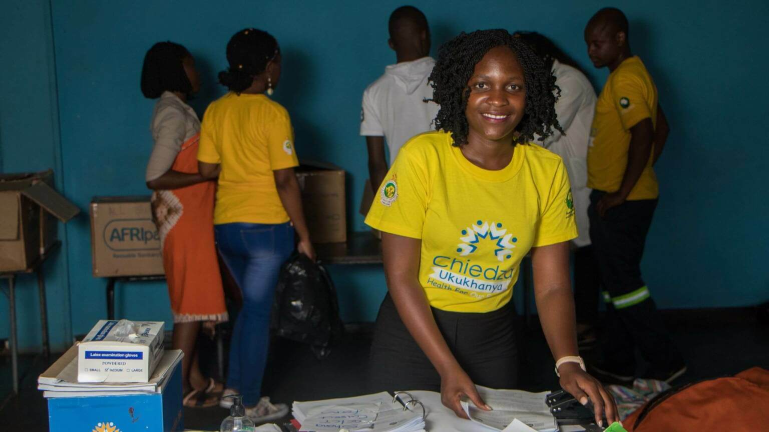 Smiling young woman in a yellow shirt