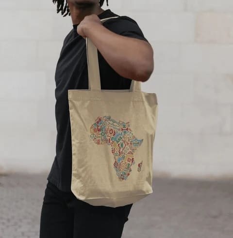 Person carrying a CTAOP Africa-design tote bag