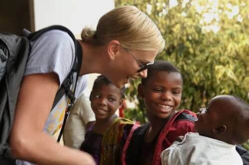 Charlize Theron with some children