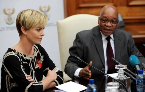 Charlize Theron sitting down with President Jacob Zuma
