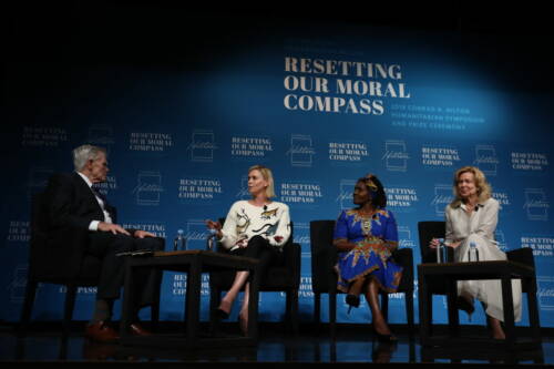 Charilze Theron sitting down for a panel discussion for 3 other people